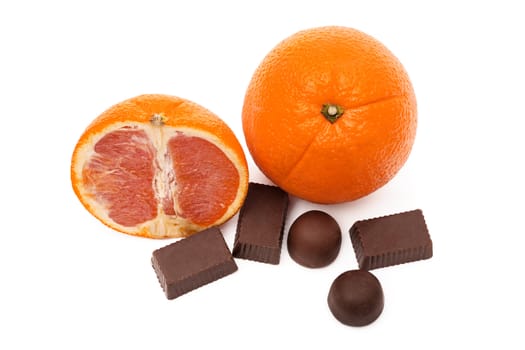 Two oranges and chocolate sweets it is isolated on a white background