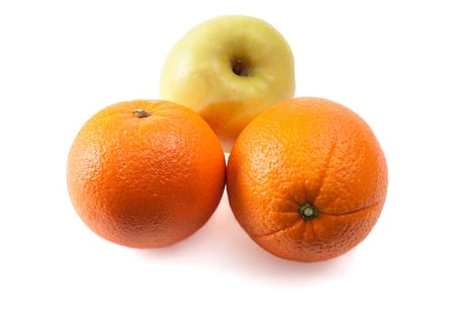 Two oranges and apple it is isolated on a white background