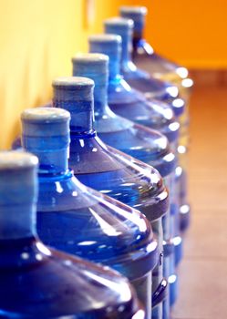 Water bottles with contents lined up ready for delivery.