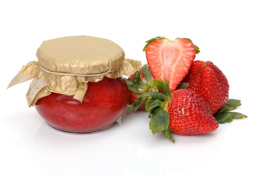 Fresh Strawberries with jam-jar closeup over white background