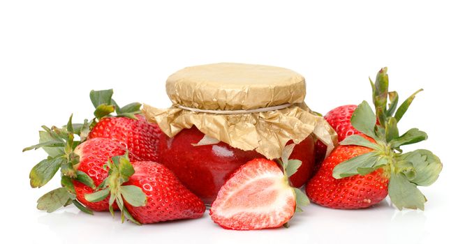 Fresh Strawberries with jam-jar closeup over white background