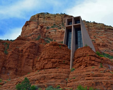 The Chapel Of The Holy Cross is a very impressive landmark in Sedona, Arizona. The location of the church on the side of the rock cliff gives a feeling of power and strength to the cross, which the building is designed around.