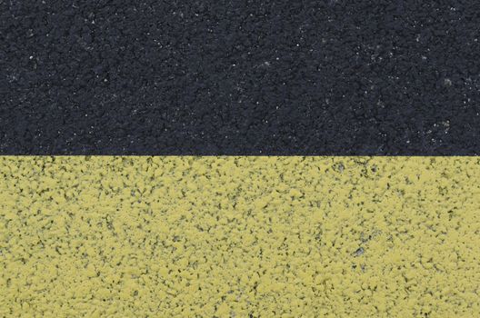 yellow marking on asphalt, textured background