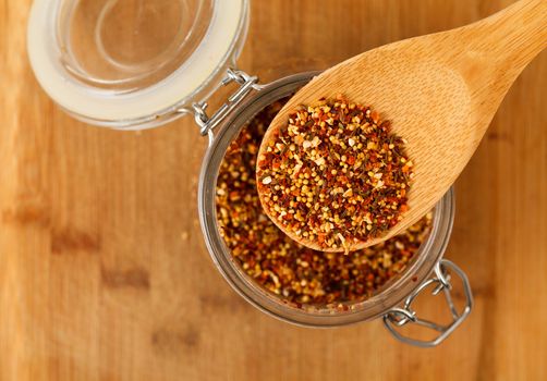 mixture spice in a wooden spoon, closeup