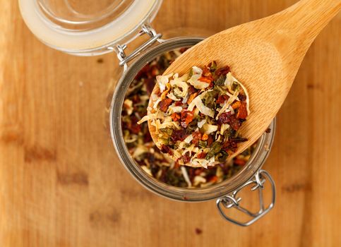 mixture spice in a wooden spoon, closeup