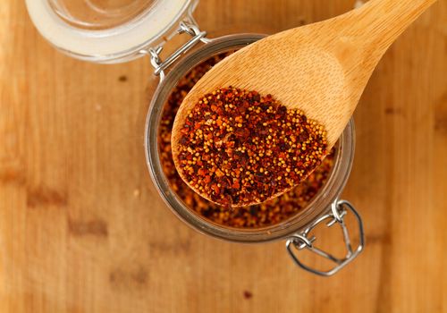 mixture spice in a wooden spoon, closeup