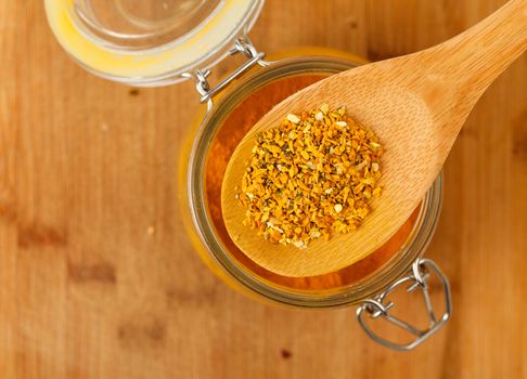 spice saffron and pepper in a wooden spoon, closeup