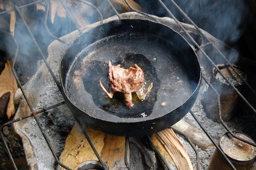 Fried wild bird on the pan, village in Papua New Guinea