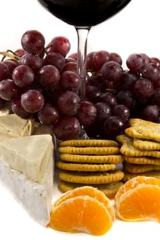 Picture of grapes with crackers, cheese and a red wine glass