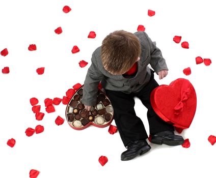 A young boy enjoys a box of valentine candy