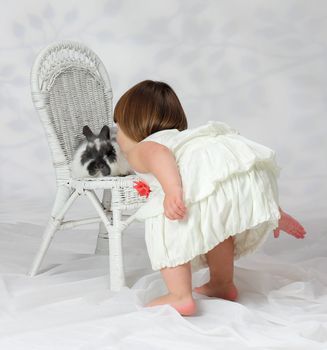 A young girl shows a loving affection to a domesticated animal