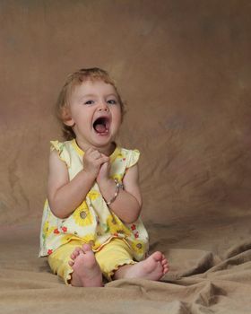 A young girl opens her mouth in glee