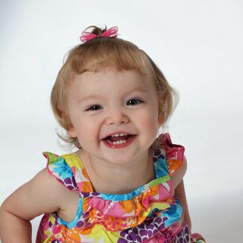 A young girl shows her teeth with a big laugh and smile