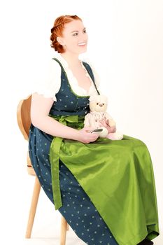 Stitz Bavarian woman with teddy bear on a chair