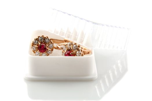 Rose gold earrings with ruby and diamonds in a gift box