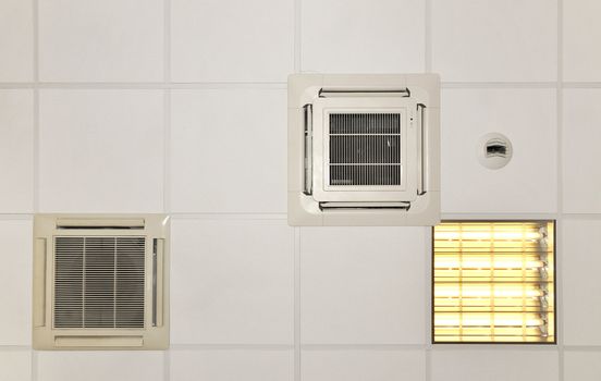 Air conditioner systems in place with light on a white roof