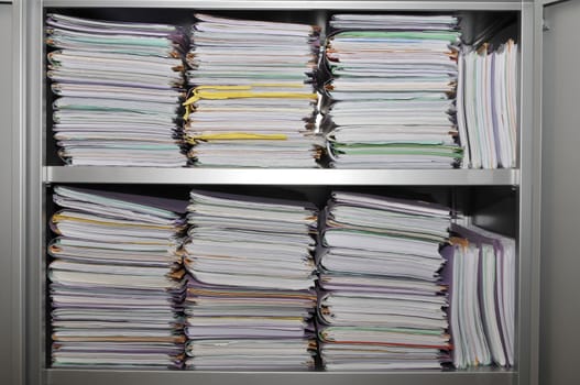 Many stacks of folders in a cupboard