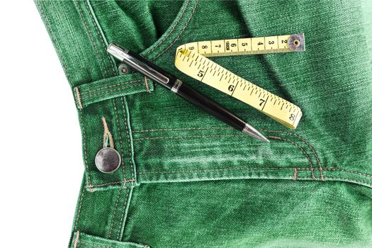 Pen and measuring tape on jeans