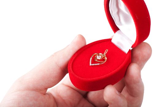 Red gift box with jewellery in a hand