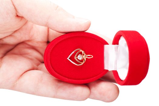 Red gift box with jewellery in a hand