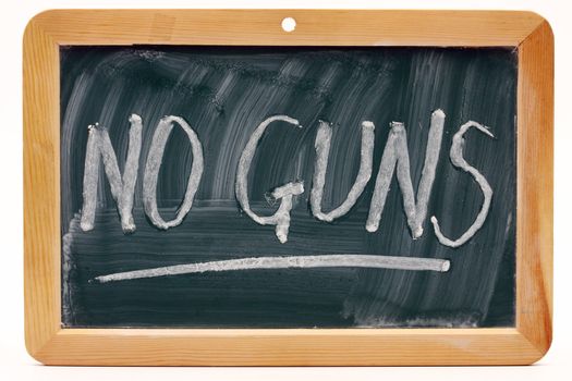 No guns message written on a blackboard 