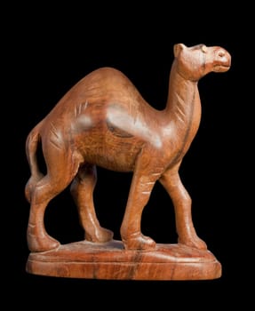 wooden dromedary sculpture isolated on black with clipping path