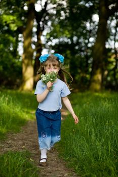 Girl running on a lane in the summer park