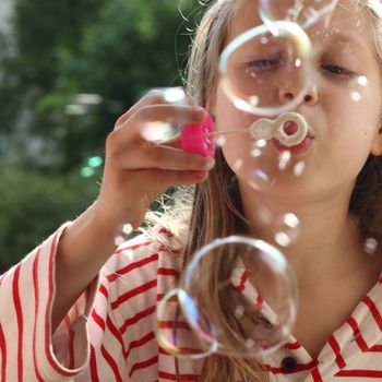 An image of a nice girl making bubbles