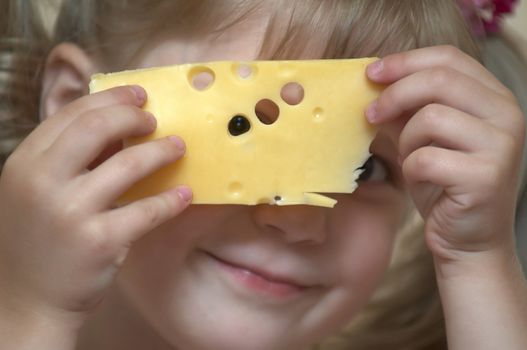 Girl holding a slice of cheese