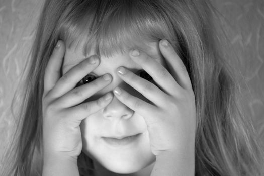 An black and white image of girl hiding her face