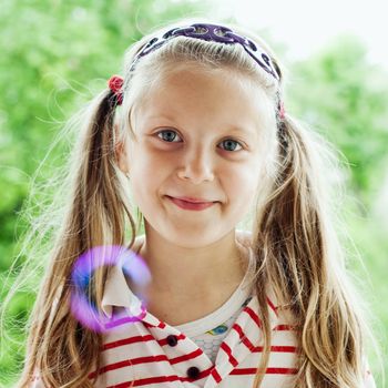 An image of a nice little girl with bubbles