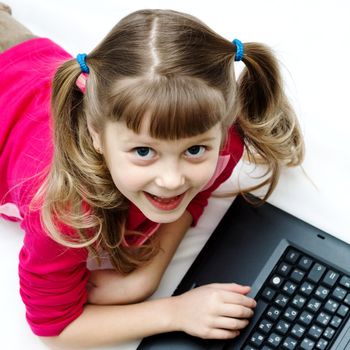 An image of a pretty girl with laptop on the floor