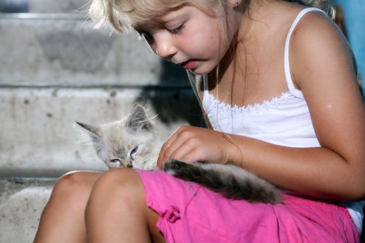 Friends. Nice girl with a kitten in her arms