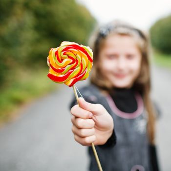 An image of girl wit lollipop in his hand