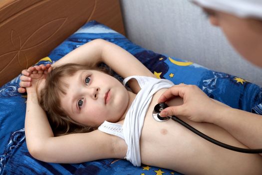 An image of a little girl and a hand with phonendoscope