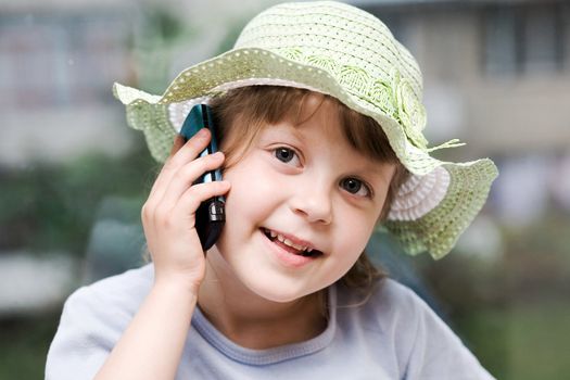 An image of nice young girl speaking on the phone