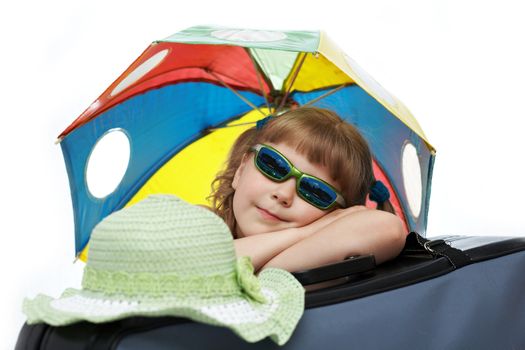 A girl with umbrella on a valise