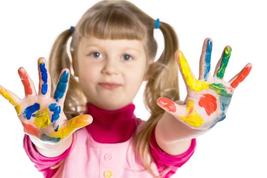 An image of a little girl with her hands  in paint