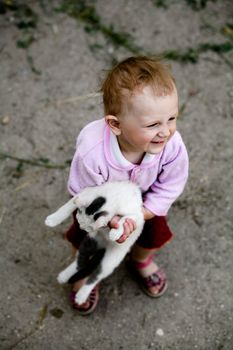 The happy young girl with a cat in her arms