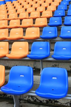 plastic, yellow and blue, new chairs in stadium.