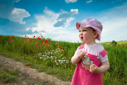 Nice girl on the lane amongst green field