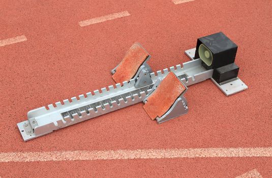 Athletics Starting Blocks on a red running track in a stadion