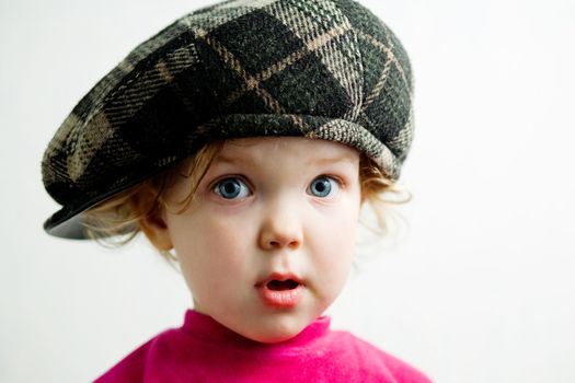 Stock photo: an image of a little nice girl in brown cap