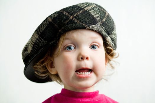 Stock photo: an image of a little girl in brown cap