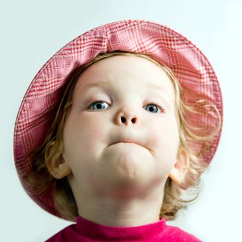 Stock photo: an image of a playful  baby in a pink hat