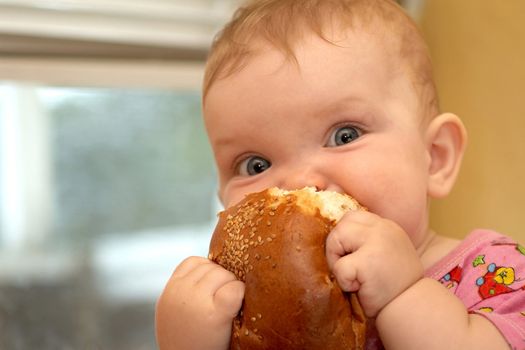 A child biting a bun