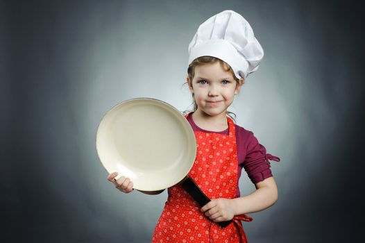 An image of a happy girl in white hat with frying pan