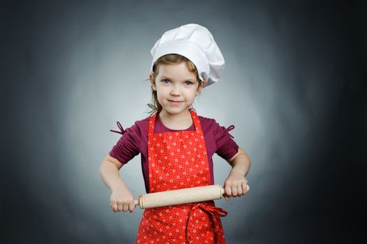 An image of a nice girl in a white hat with a rolling-pin