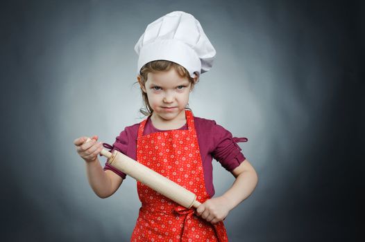 An image of a girl with a rolling pin in her hands