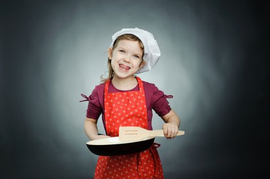 An image of a funny girl in white hat with frying pan